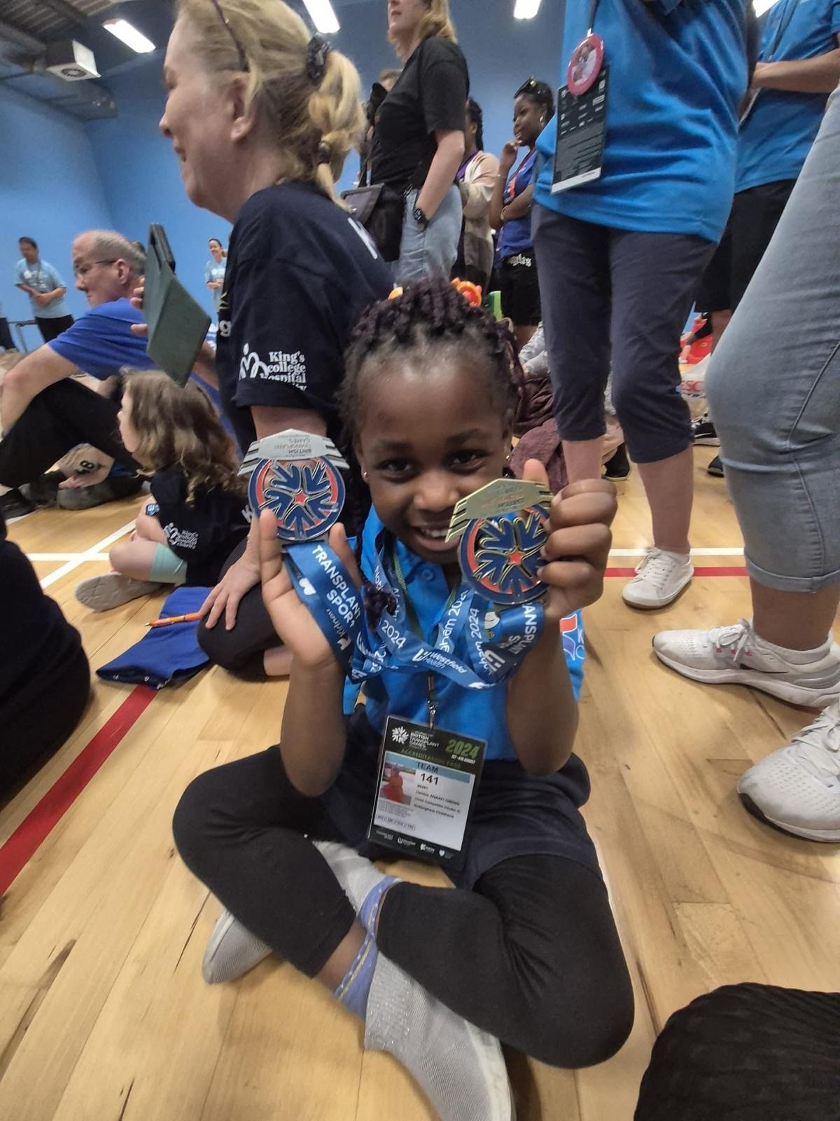 D with medals at obstacle race